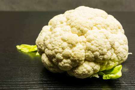 White cauliflower on a wooden dark table.の写真素材
