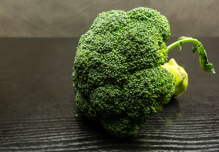Green fresh broccoli on a wooden dark table.の写真素材