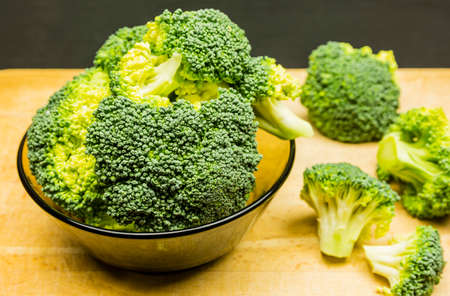 Fresh broccoli in a bowl on a wooden background.の写真素材