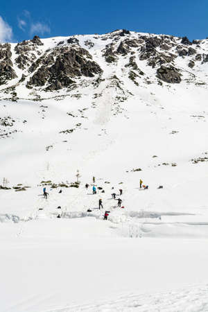 Zakopane, Poland - April 07, 2018: Winter mountaineering course. A group of trainees trains pulling out of a crevasse in the glacier.のeditorial素材