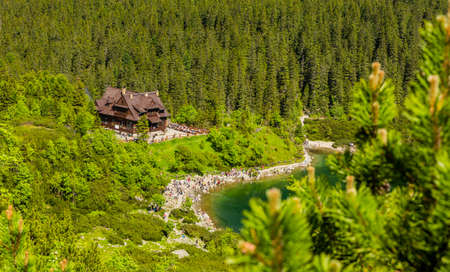 Zakopane, Poland - May 28, 2018: PTTK mountain chalet by the lake Sea Eye (Morskie Oko) in Polish Tatra Mountains and tourists resting in its surroundings.のeditorial素材