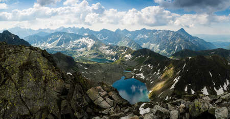 Dark storm clouds begin to gather over the mountains. Extensive High Tatra Mountains panorama.の写真素材