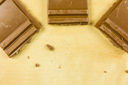Cubes of dark sweet chocolate on the table.
