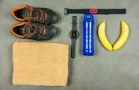 Niedomice, Poland - June 08, 2018: Attributes of the running person - shoes, sports watch, isotonic drink, banana.のeditorial素材