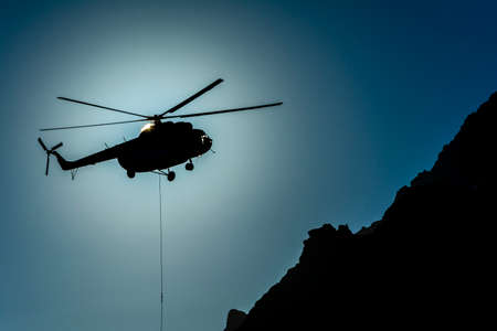 Stary Smokovec, Slovakia - October 12, 2018: Helicopter Type Mil Mi-8T. Helicopter (om-eva) in the mountains on the background of the sun shield.のeditorial素材