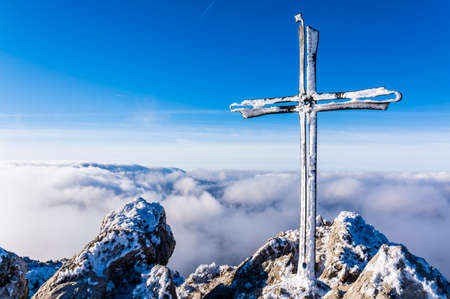 Frosted cross on a mountain peak Velky Rozsutec in Mala Fatra in Slovakia. The peak is situated in the north part of Mala Fatra (Little Fatra) called Krivanska Mala Fatra.の写真素材