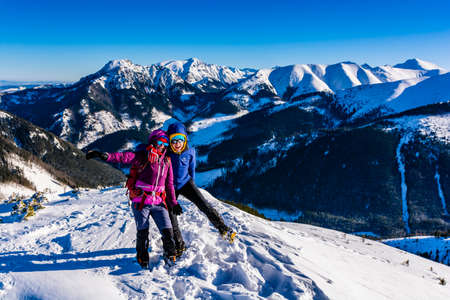 Witow, Poland - January 07, 2020: Winter in the mountains. Happy girls posing against the backdrop of a snowy ridge.のeditorial素材
