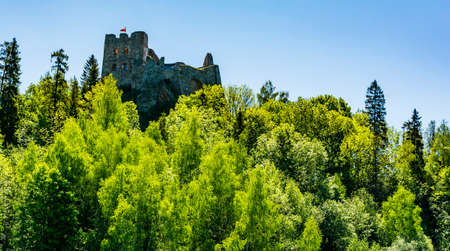 Czorsztyn, Poland - June 06, 2020: The ruins of the castle in Czorsztyn, the Polish flag flies over the tower.のeditorial素材