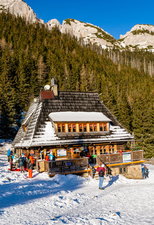 Zakopane, Poland - December 27, 2020: PTTK shelter on Hala Kondratowa them. Wladyslaw Krygowski and tourists visiting it on Sunday afternoon.のeditorial素材
