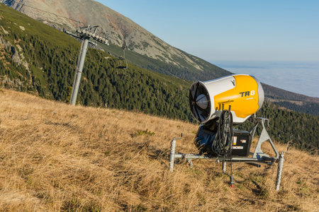 Strbske Pleso, Slovakia - November 15, 2021: Yellow Technoalpin TR8 snow cannon set up on the slope....