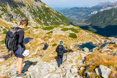 Palenica Bialczanska, Poland - September 11, 2021: Couple of tourists while descending the stone path into the valley from the mountains.のeditorial素材