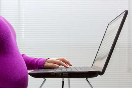 Pregnant woman working from homeの写真素材