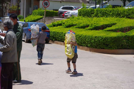 Two children holding a bag of plastic bottlesのeditorial素材