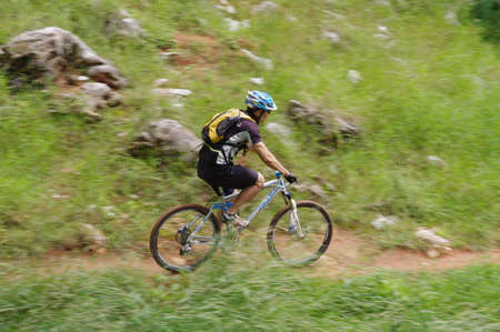 Man cycling through the hill trailsのeditorial素材