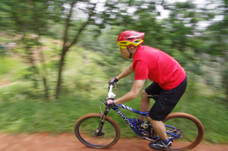 Man cycling through the hill trails