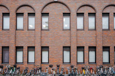 Bicycle park and brown brick buildingのeditorial素材