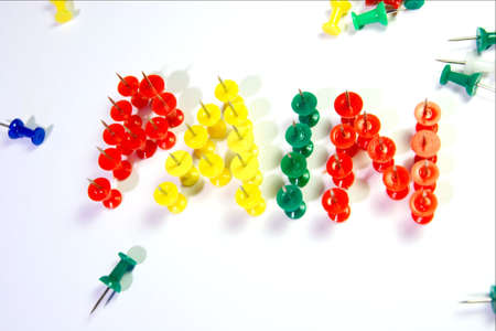 Pushpins forming the word "pain" on white backgroundの写真素材