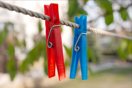 Closeup of two clothes-pegs on a ropeの写真素材
