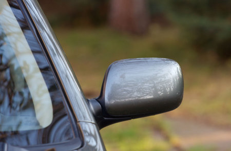 Rightside mirror of a shiny gray car
