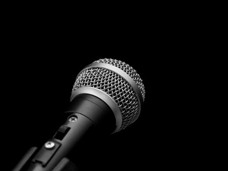 Closeup of a dynamic microphone isolated on blackの写真素材
