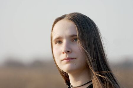 portrait of a girl with long hair in the windの写真素材
