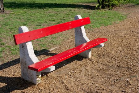 Empty red bench in a peaceful parkの写真素材