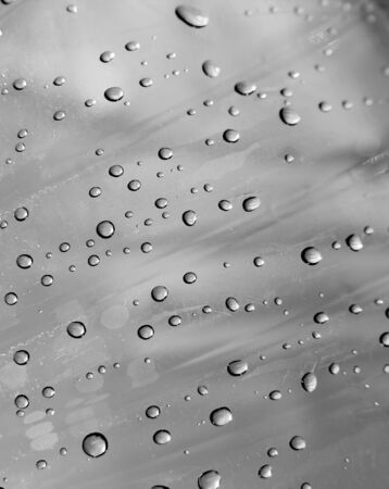Closeup of small water droplets on a gray surfaceの写真素材