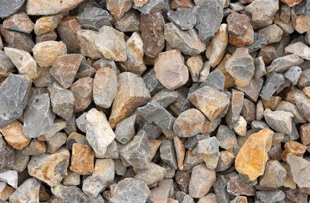 A pile of small rusty stones between railway tracks
