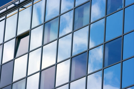 Detail of a modern office building with sky reflection