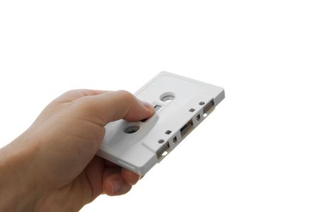 Human hand holding an audio cassette isolated on whiteの写真素材