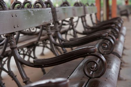 Dark brown benches of a railway stationの写真素材