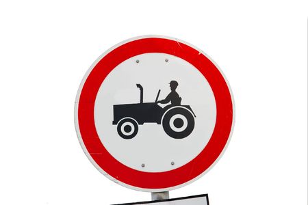 Traffic sign prohibiting the entry of tractors isolated on whiteの写真素材