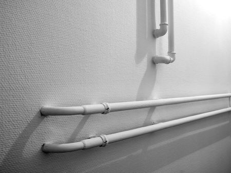 pipes of a building's heating system on the wallの写真素材