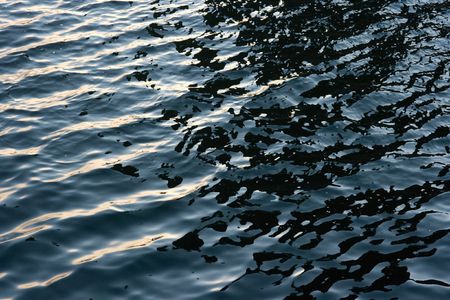 Waving dark blue water surfaceの写真素材
