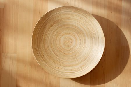 Wooden bowl on the carpetの写真素材