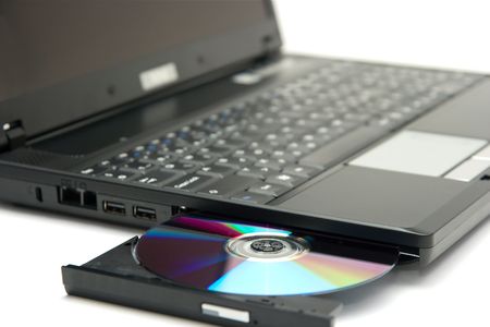 Laptop with a cd in the trayの写真素材