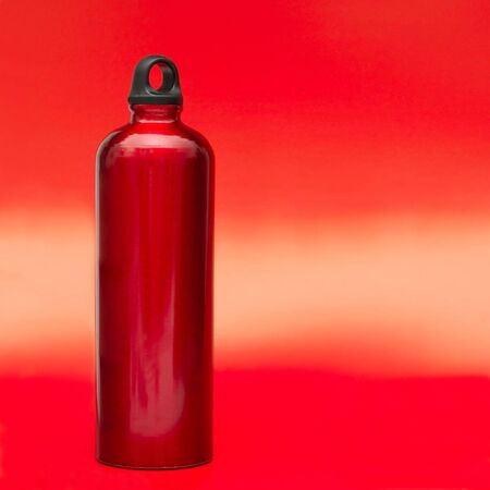Aluminum water flask on red backgroundの写真素材