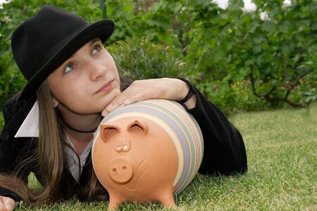 Girl with piggy bankの写真素材