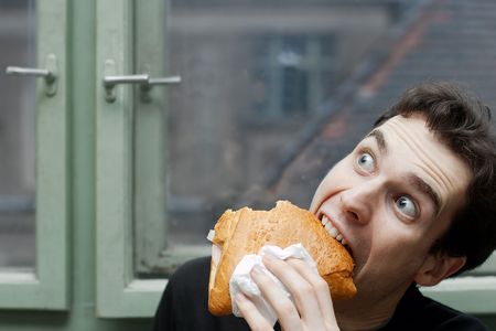 Man eating with silly expressionの写真素材
