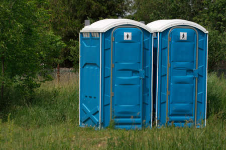Blue mobile toilet cabins in an outdoor sceneの写真素材