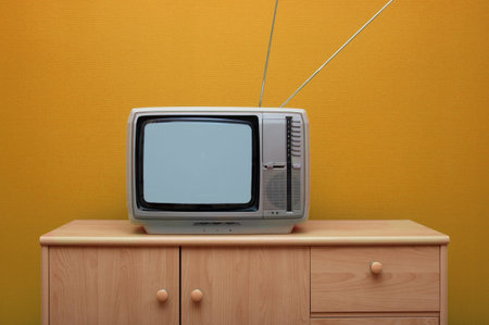 Vintage TV set, orange wallの写真素材