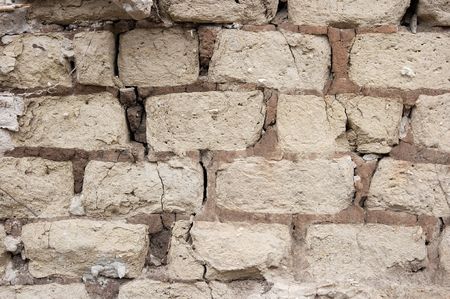 Old wall with aged adobe bricksの写真素材