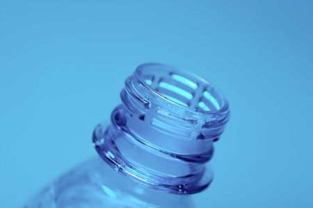 Neck of an open plastic water bottle on blue backgroundの写真素材