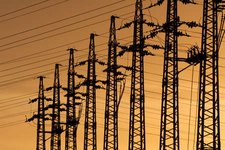 Electric lines at a substation against evening skyの写真素材