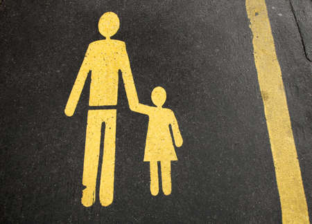 Pedestrians walking sign painted on asphalt pavementの写真素材