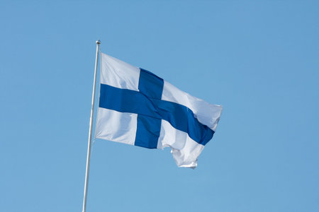 Finnish national flag against clear blue skyの写真素材