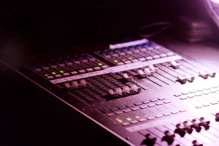 Soundboard mixer at a concert in the darkの写真素材