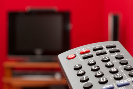 Remote controller with tv in the background