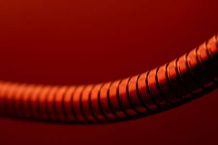 Abstract metal tube in red lightの写真素材
