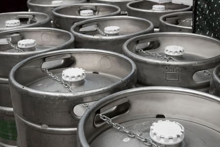 Metal beer barrels in rows in the factoryの写真素材